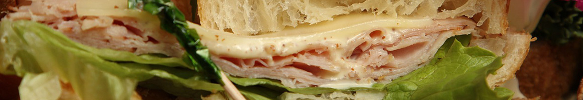 Eating Sandwich at Roland Park Bagels restaurant in Baltimore, MD.